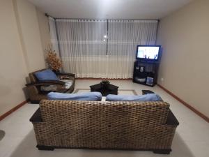 a living room with two couches and a tv at Habitaciones en Acogedora estancia en pleno centro de Ibagué in Ibagué
