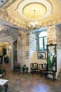 a room with a stone wall and a ceiling at Akkotel-Boutique hotel in ‘Akko