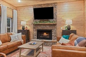 a living room with a fireplace and a tv at Mins to Gburg Sleeps 8 Hot Tub Arcade Area Pool in Gatlinburg
