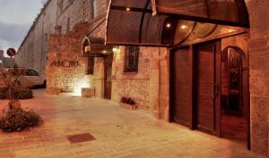 
a building with a clock on the side of it at Akkotel-Boutique hotel in Acre
