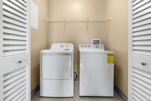 two washers and a refrigerator in a laundry room at Bali Bay 301 OV Myrtle Beach Hotel Room in Myrtle Beach
