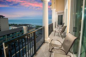 a balcony with chairs and a view of the ocean at Bali Bay 401 OV Myrtle Beach Hotel Room in Myrtle Beach