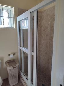 a shower in a bathroom with a glass door at Belle Cove in Gros Islet