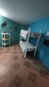 a bedroom with two bunk beds in a blue wall at Castaways Villa in Duncans