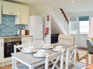 a kitchen and dining room with a table and chairs at Sanderling - Uk32837 in Hodgeston