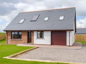 a house with solar panels on the roof at Seascape in Mainsriddle