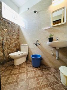 a bathroom with a toilet and a sink at Raja Residency in Alāndurai