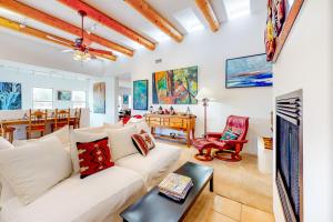 a living room with a white couch and a table at Casa Vistoso in Santa Fe