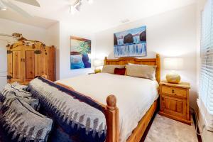 a bedroom with a wooden bed and a dresser at Casa Vistoso in Santa Fe