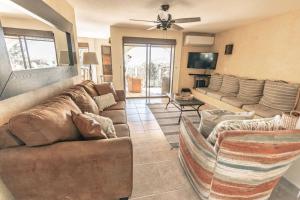 a living room with a couch and a tv at 3 Bed 4 bath Ocean View with Heated Pool. in El Pueblito