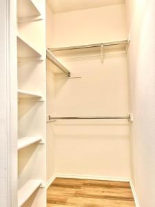 a walk in closet with white shelves at Le Jardin - Remote Work Getaway in SoCal in Irvine