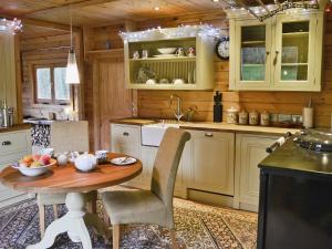 a kitchen with a table with a bowl of fruit on it at Ash Mill Cabin in Ashreigney