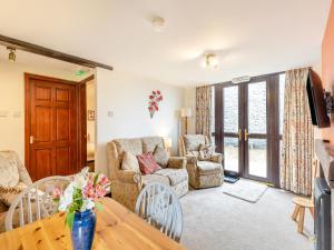 a living room with a table and a couch at Poppies Court Jericho Farm in Earl Sterndale