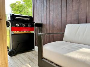 - un barbecue installé à côté d'un lit dans une véranda dans l'établissement Country Nirvana, à Pataua