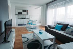 a living room with a couch and a table at ASPERA Apartments in Kumanovo