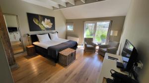 1 dormitorio con 1 cama y TV en una habitación en The Barnyard, en Balinge