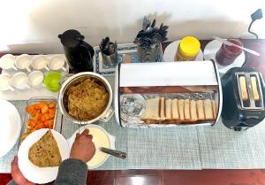 a table with food on it with a plate of food at The Di-Lac Retreat in Gangtok