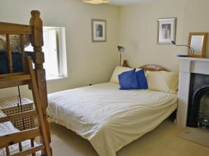 a bedroom with a bunk bed and a fireplace at Rose Cottage in Rochester