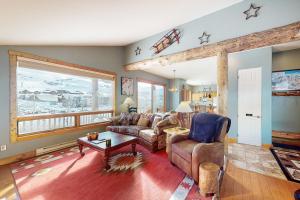 a living room with a couch and a table at Snowmass Haven in Crested Butte