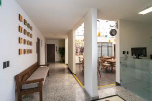 a hallway with a bench and a dining room at Casa Sofía Hotel Boutique in Atlacomulco de Fabela