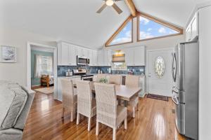 a kitchen and dining room with a table and chairs at The Sandy Eagle in Kill Devil Hills