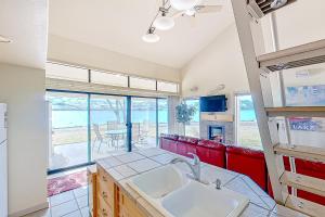 a kitchen with a sink and a large window at Lake Chelan Shores The Lake Escape 3 1 in Chelan
