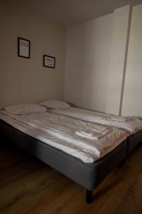 a large bed in a bedroom with two pictures on the wall at Studio King'sRoad in Kuopio