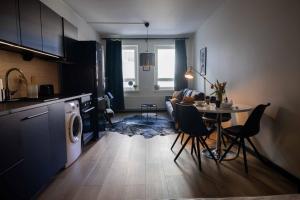 a kitchen and a living room with a table and chairs at Studio King'sRoad in Kuopio