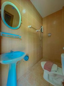 a bathroom with a sink and a toilet and a mirror at View Garden Resort in Phi Phi Islands
