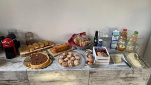 a table with many different types of bread and pastries at Il Salice b&b in Olbia