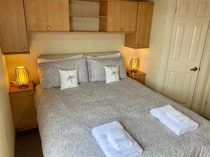 a bedroom with a large bed with two pillows at Earls View Caravan in Carna