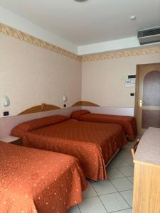 Postel nebo postele na pokoji v ubytování Hotel Ambra