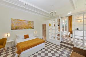 a bedroom with a bed and a checkered floor at Boutique Hôtel Château Beaupin Restaurant & Wellness in Marseille +37 photos