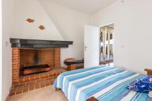 una camera con letto e camino di Casa Jonica by BarbarHouse a San Pietro in Bevagna