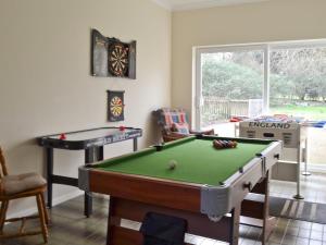 a living room with a pool table and a table at West View in Sturminster Marshall