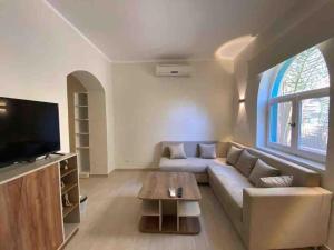a living room with a couch and a tv at Stay in the center of Elgouna in Hurghada