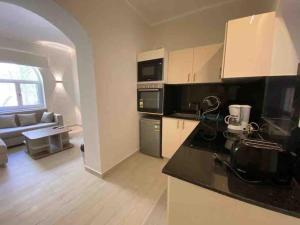a kitchen and living room with a couch and a table at Stay in the center of Elgouna in Hurghada