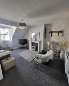 a living room with a couch and a fireplace at Willesden, Flat 2, A 1 Bedroom flat right in the heart of Llandudno in Llandudno