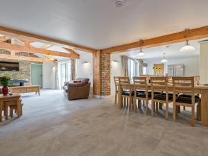 a large living room with a table and chairs at Eastlands Barn in East Barkwith