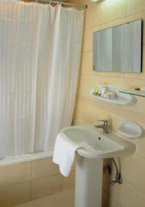 a bathroom with a sink and a shower curtain at New Royal Palace Hotel Apartments in Ajman 