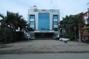 a large building with a dog in front of it at HOTEL SAI PASO in Shirdi