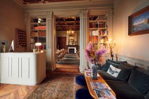 a living room with a couch and a dining room at Boutique Hôtel Château Beaupin Restaurant & Wellness in Marseille