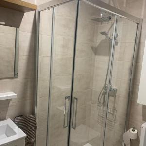 una doccia con porta in vetro in bagno di Apartamento Sotavento Chipiona a Chipiona