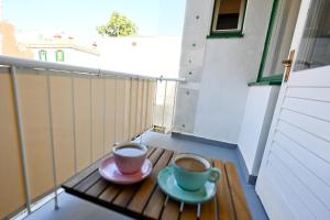 twee kopjes koffie op een tafel op een balkon bij Apartment Old Town in Zadar