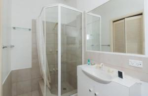 a bathroom with a shower and a sink and a mirror at M104 West Perth Studio Apartment near Kings Park in Perth +3 photos