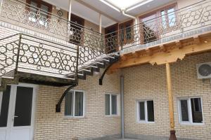 a balcony on the side of a brick building at HAVAS Guest House in Bukhara