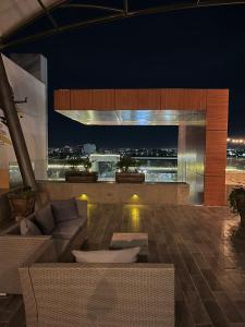 a living room with a view of a city at night at Zújmú Business Boutique Hotel in Aguascalientes