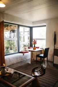 a living room with a couch and a table at Strawbale Cottage - Wingspread Garden in Strath Creek