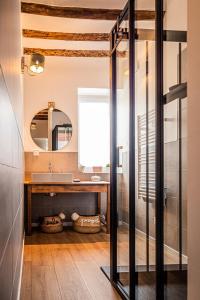 a bathroom with a sink and a mirror at Gîte Le carré 1869 in Landas