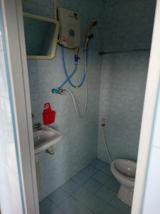 a bathroom with a shower and a sink and a toilet at NP guesthouse in Trat